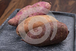 Colorful root vegetables pink, purple and orange organic sweet potatos