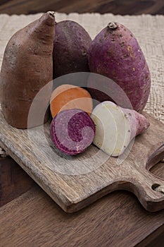 Colorful root vegetables pink, purple and orange organic sweet potatos