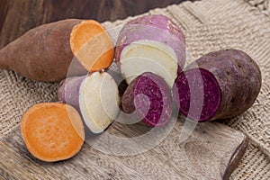 Colorful root vegetables pink, purple and orange organic sweet potatos