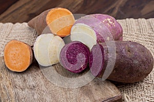 Colorful root vegetables pink, purple and orange organic sweet potatos