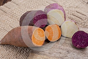 Colorful root vegetables pink, purple and orange organic sweet potatos