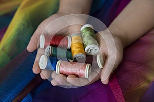 The colorful ropes on the hand on background.