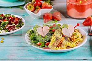 Colorful rotini, hearts from hot dogs and veggies salad. Valentines Day concept