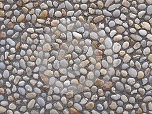 Colorful and round stones, stone wall texture, road made of small boulders and sea stones