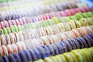 Colorful roundish sweets macarons in a box on the showcase of th
