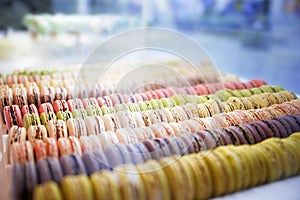 Colorful roundish sweets macarons in a box on the showcase of th