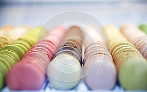 Colorful roundish sweets macarons in a box on the showcase of th