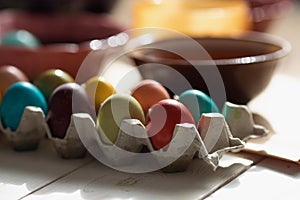 Colorful Row dyed Easter eggs in a carton on table