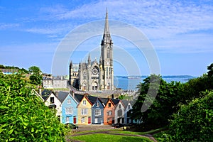 Colorful row houses with cathedral in background, Cobh, County Cork, Ireland