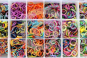 Colorful rubber bands in a box texture background