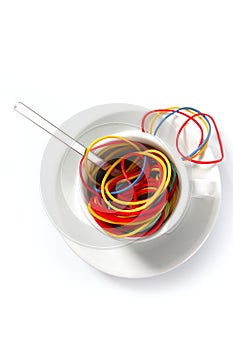 Colorful rubber bands in breakfast cup