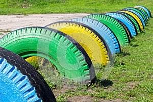 Colorful rubber tires on the green grass