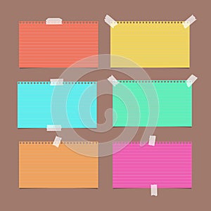 Colorful ruled, striped note, copybook, notebook paper sheet on brown background. photo