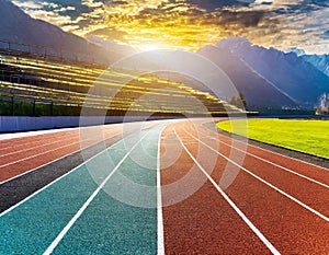 Colorful running track lanes in sunlight, dynamic and sporty concept
