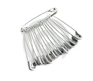 Colorful safety pins on white background, top view