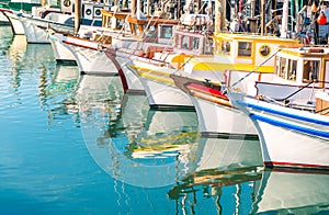 Colorful sailing boats at Fishermans Wharf of San Francisco Bay