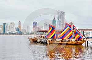 Colorful sails hoisted on a traditional Filipino boat called a balangay.