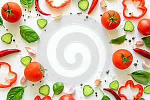 Colorful salad ingredients pattern made of tomatoes, pepper, chili, garlic, cucumber slices and basil on white background