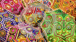 A colorful scene of ornamental parasols in India, with vibrant colors and traditional patterns.