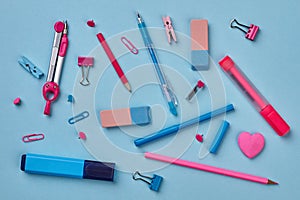 Colorful school supplies on blue background.