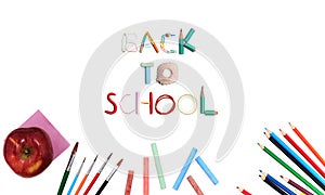 Colorful school supplies corner border over a white background with words Back to school