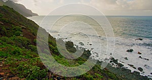 Colorful sea beach, waves foaming and splashing on the rocky shoreline. Ocean waves in open sea at Tenerife north, Anaga