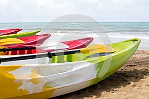 Colorful sea kayaks on sand beach