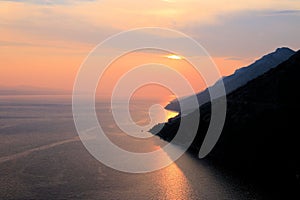 Colorful sea and sundown clouds between Brela and Baska Voda in Dalmatia, Croatia