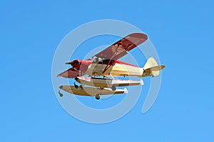 Colorful seaplane landing in vibrant blue sky