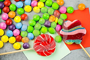 Colorful selection of candy treats laid out on multicolored sticky notes