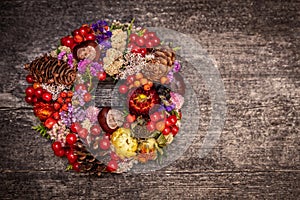 Colorful selfmade fall wreath on wooden table, concept autumn and decoration