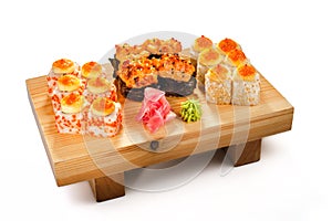 Colorful set of baked sushi with cheese, red caviar and black sesame seeds on board