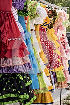 Colorful sevillana costumes at a street market in Spain photo