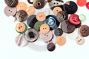 Colorful sewing buttons on white background closeup with copy space for text