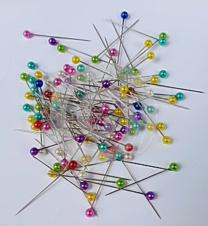 colorful sewing pins on a white background