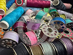 Colorful sewing thread spools and bobbins.