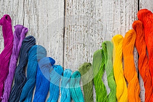 Colorful sewing threads for embroidery on white background