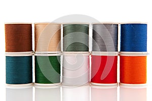 Colorful sewing threads on white spools