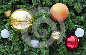 Colorful shiny christmas ball and sphere white light bulb hanging on christmas tree