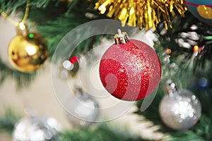 Colorful shiny Christmas toys balls on the tree for the new year holiday