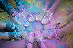 The colorful shoes and legs of teenagers at color run event