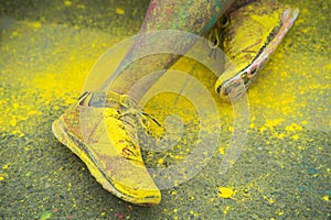 The colorful shoes and legs of teenagers at color run event