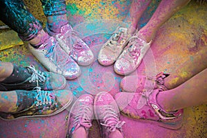 The colorful shoes and legs of teenagers at color run event