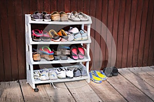 Colorful Shoes on a Plastic Shoe Rack, Outside a House