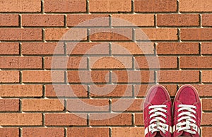 Colorful shoes set on brick background with copy space. Top view.