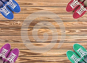 Colorful shoes set on wooden background with copy space. Top view.