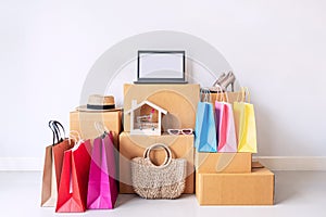 Colorful shopping bag with stack of cardboard boxes and fashion items at home, Website online shopping concept