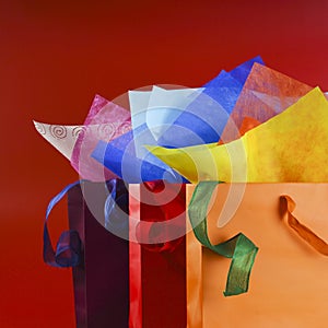Colorful shopping bags with colorful wrapping papers and ribbons