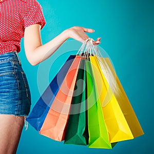 Colorful shopping bags in female hand. Sale retail