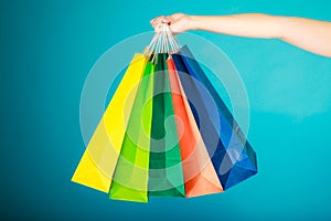 Colorful shopping bags in female hand. Sale retail